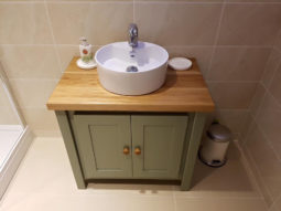 Card room green vanity unit with solid oak top