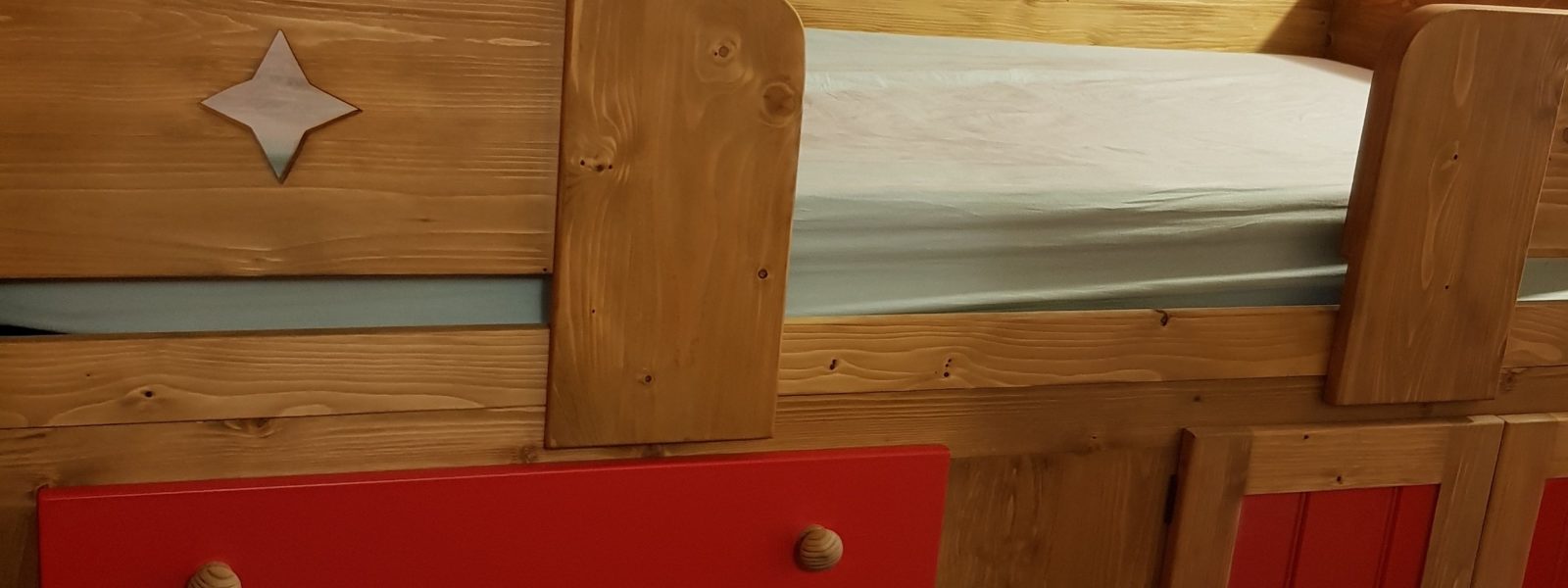 Kids cabin bed painted in red.