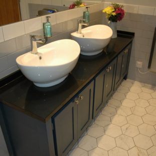 Double Countertop Sinks on Black Granite with Splashbacks